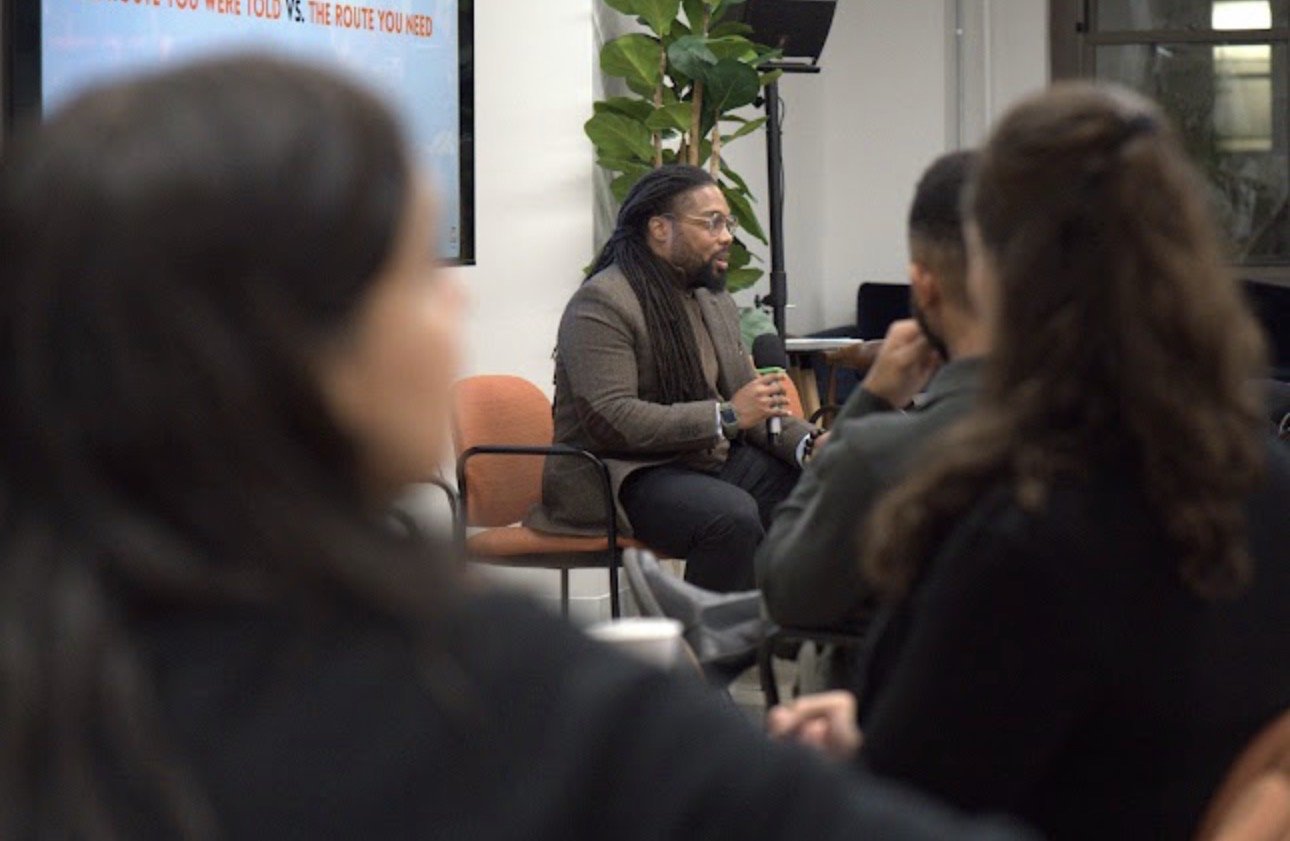 Kason Morris speaking with a microphone at a live event